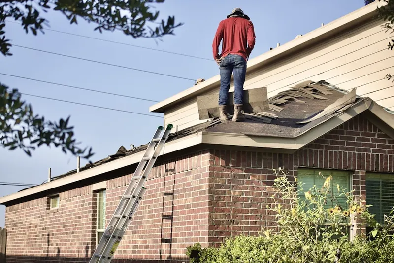 Professional roofer working on a residential roof in Minortown